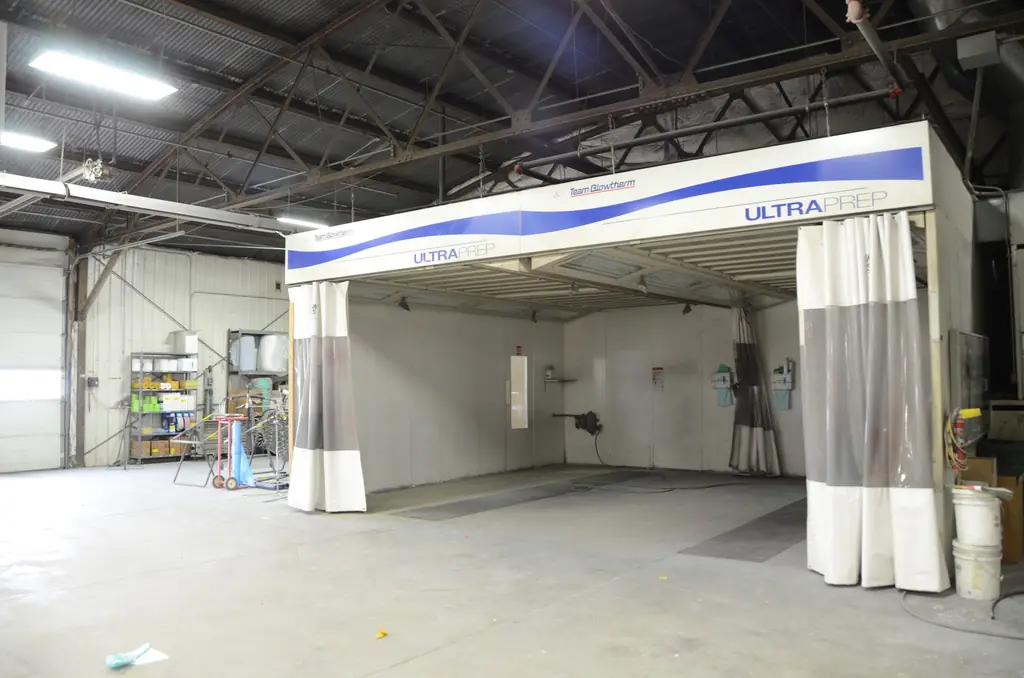 A service bay with the prep station and vehicles in for work